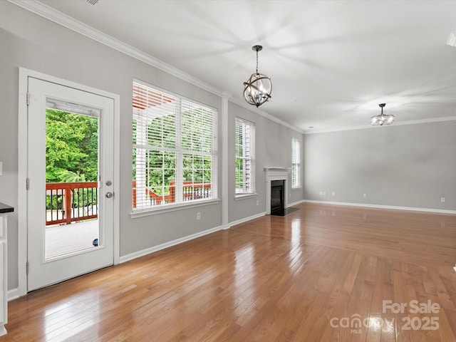 3038 Sterling Ct, Fort Mill, SC 29707 - unfurnished living room featuring a chandelier, crown molding, light wood finished floors, a fireplace with flush hearth, and baseboards