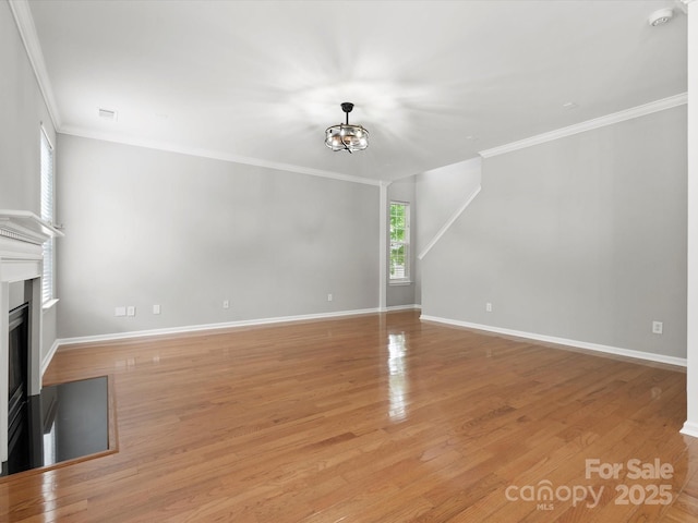 3038 Sterling Ct, Fort Mill, SC 29707 - unfurnished living room featuring ornamental molding, a fireplace, light wood-style floors, baseboards, and a chandelier