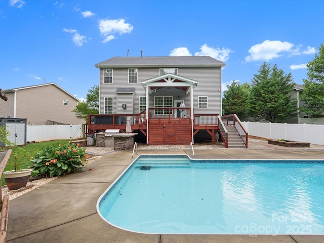 3038 Sterling Ct, Fort Mill, SC 29707 - view of swimming pool featuring a deck, stairs, a fenced backyard, a patio, and an outdoor kitchen