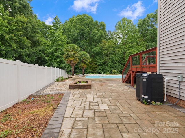 3038 Sterling Ct, Fort Mill, SC 29707 - fenced backyard with a patio, central AC unit, stairs, and view of wooded area