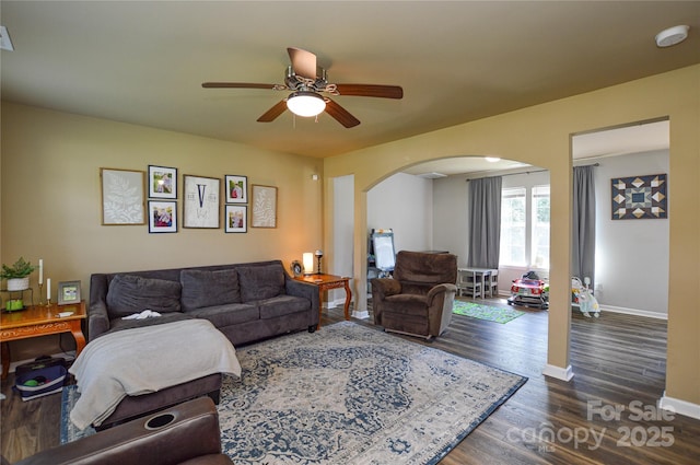 4075 Clover Rd NW, Concord, NC 28027 - living room with arched walkways, a ceiling fan, wood finished floors, and baseboards