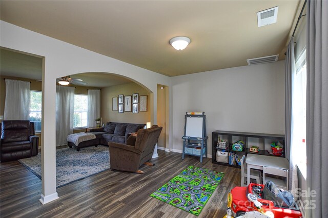 4075 Clover Rd NW, Concord, NC 28027 - living room with arched walkways, dark wood-style floors, baseboards, and a ceiling fan
