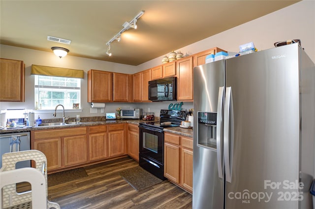 4075 Clover Rd NW, Concord, NC 28027 - kitchen with black appliances, a sink, dark wood-type flooring, rail lighting, and dark countertops