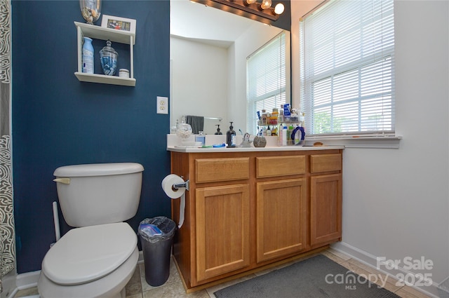 4075 Clover Rd NW, Concord, NC 28027 - bathroom with vanity, tile patterned flooring, toilet, and baseboards