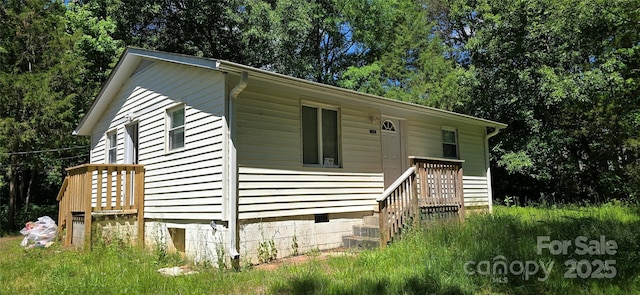view of home's exterior featuring view of wooded area