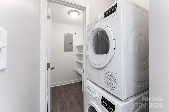 laundry room featuring electric panel, dark wood finished floors, stacked washer / dryer, and baseboards