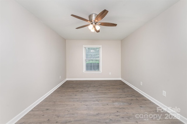 empty room featuring ceiling fan, baseboards, and wood finished floors
