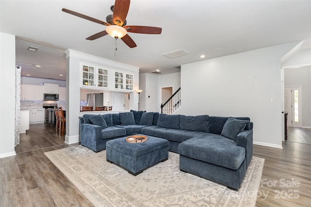 9593 Indian Beech Ave NW, Concord, NC 28027 - living room featuring wood finished floors, ceiling fan, stairs, baseboards, and recessed lighting
