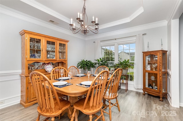 9593 Indian Beech Ave NW, Concord, NC 28027 - dining room with a chandelier, light wood finished floors, and ornamental molding