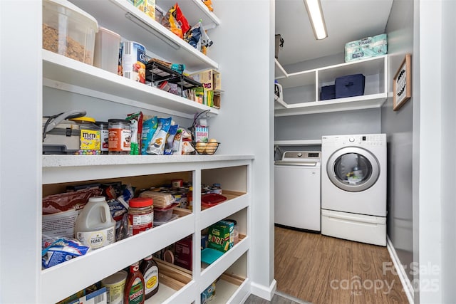 9593 Indian Beech Ave NW, Concord, NC 28027 - laundry room with washing machine and clothes dryer, wood finished floors, and baseboards