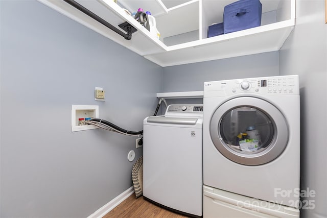 9593 Indian Beech Ave NW, Concord, NC 28027 - laundry area featuring light wood-style floors, washing machine and dryer, and baseboards