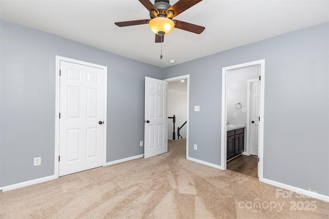 9593 Indian Beech Ave NW, Concord, NC 28027 - unfurnished bedroom featuring carpet flooring, baseboards, ensuite bathroom, and ceiling fan
