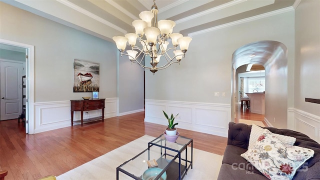 8605 Soaring Eagle Ln, Waxhaw, NC 28173 - sitting room featuring arched walkways, wood finished floors, a decorative wall, a chandelier, and ornamental molding