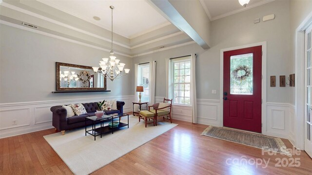 8605 Soaring Eagle Ln, Waxhaw, NC 28173 - entryway with a chandelier, wood finished floors, a wainscoted wall, ornamental molding, and a decorative wall