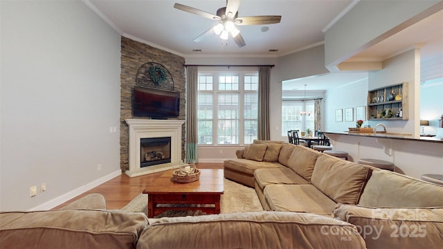 8605 Soaring Eagle Ln, Waxhaw, NC 28173 - living room with ceiling fan, wood finished floors, a large fireplace, crown molding, and baseboards