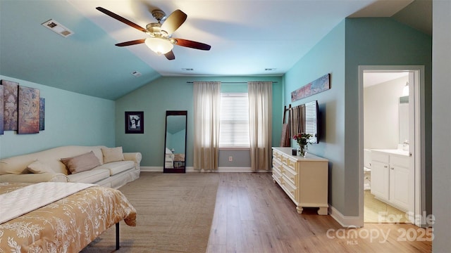8605 Soaring Eagle Ln, Waxhaw, NC 28173 - bedroom with lofted ceiling, light wood-style floors, baseboards, a ceiling fan, and ensuite bath