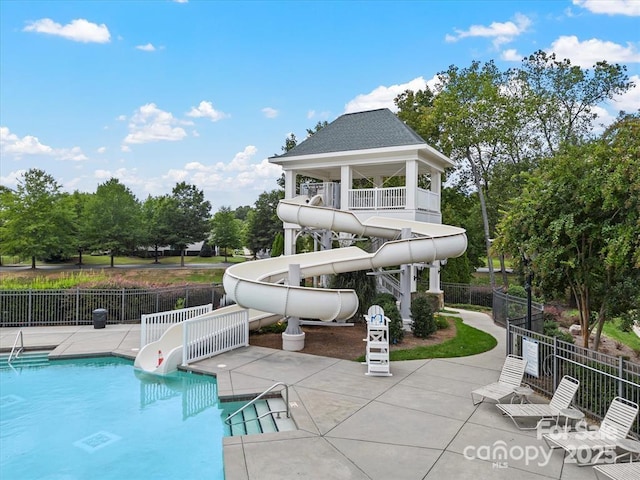 8605 Soaring Eagle Ln, Waxhaw, NC 28173 - view of swimming pool featuring a water slide, a patio area, and view of scattered trees
