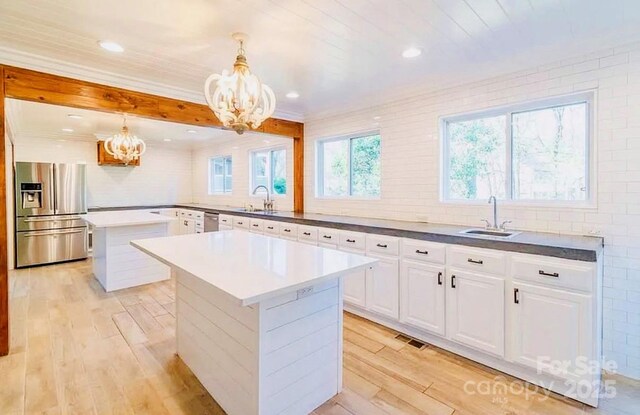 3921 Bon Rea Dr, Charlotte, NC 28226 - kitchen with appliances with stainless steel finishes, a chandelier, a center island, a sink, and recessed lighting