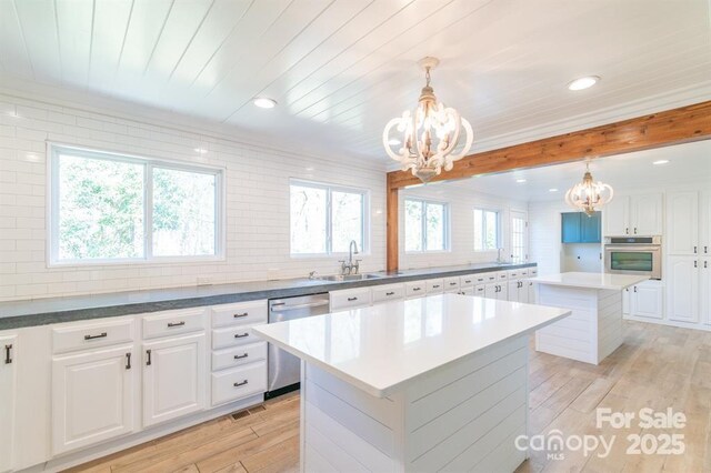 3921 Bon Rea Dr, Charlotte, NC 28226 - kitchen featuring appliances with stainless steel finishes, a chandelier, a kitchen island, a sink, and recessed lighting