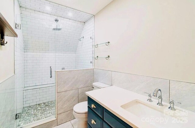 3921 Bon Rea Dr, Charlotte, NC 28226 - full bathroom with tile walls, a shower stall, toilet, vanity, and tile patterned flooring