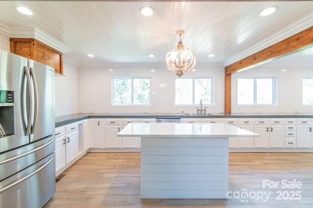 3921 Bon Rea Dr, Charlotte, NC 28226 - kitchen with appliances with stainless steel finishes, a chandelier, tasteful backsplash, recessed lighting, and a sink