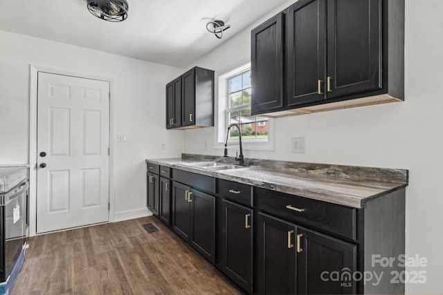 330 Willow Oak Cir, Lancaster, SC 29720 - kitchen featuring a sink, dark wood-style flooring, dark cabinets, and baseboards