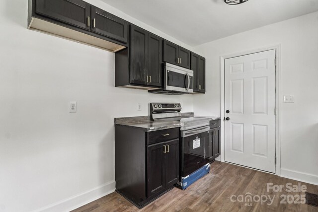 330 Willow Oak Cir, Lancaster, SC 29720 - kitchen with stainless steel appliances, dark cabinetry, baseboards, and dark wood-type flooring