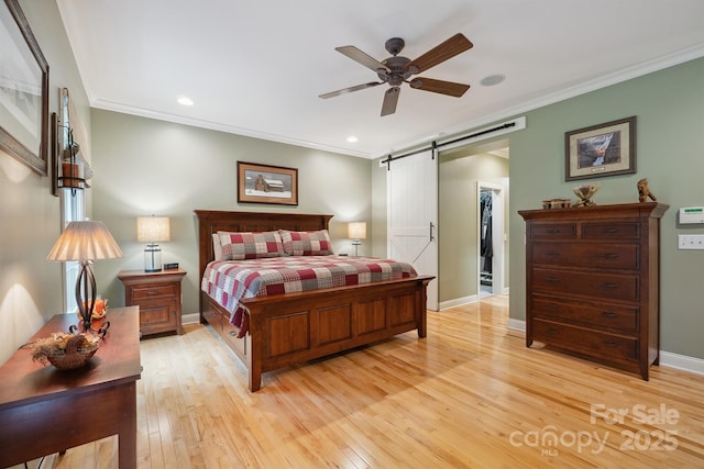 270 N St, Salisbury, NC 28147 - bedroom featuring a barn door, ornamental molding, light wood finished floors, baseboards, and recessed lighting