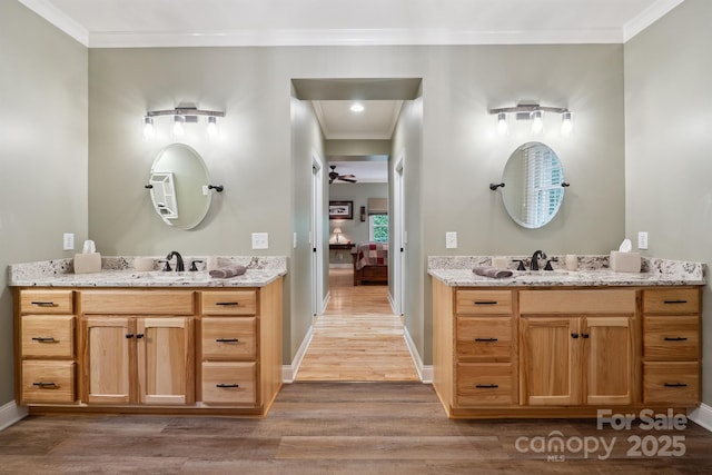 270 N St, Salisbury, NC 28147 - bathroom featuring two vanities, wood finished floors, crown molding, ensuite bath, and baseboards