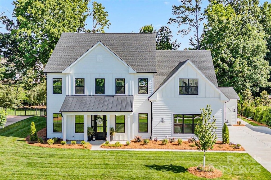1149 Rosecliff Dr, Waxhaw, NC 28173 - view of front of property with board and batten siding, concrete driveway, a shingled roof, a standing seam roof, and metal roof