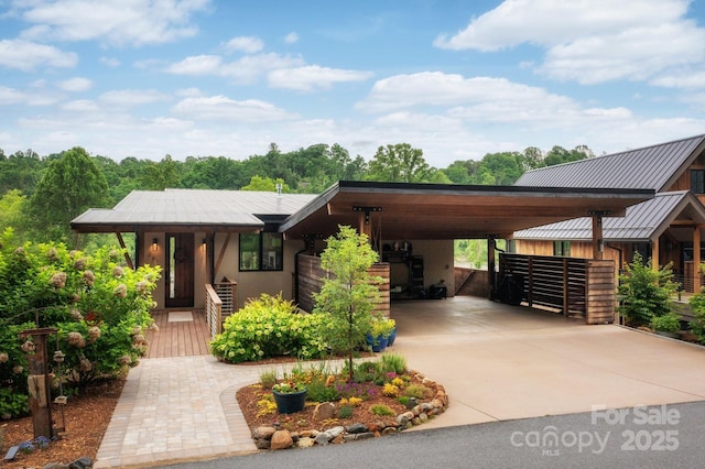 34 River Run, Asheville, NC 28804 - view of front of property with an attached carport, a standing seam roof, concrete driveway, metal roof, and stucco siding
