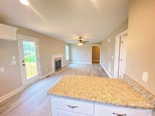 1872 Terrain Dr NW, Conover, NC 28613 - kitchen featuring white cabinetry, ceiling fan, light wood-style floors, and light stone countertops