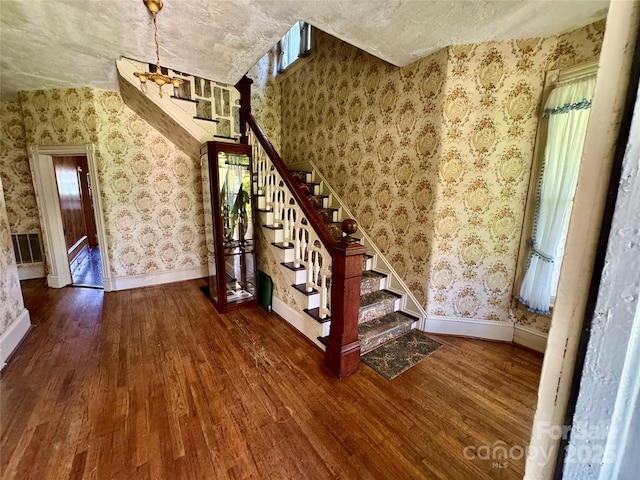 4689 Lakeview Acres Rd, Valdese, NC 28690 - staircase featuring wood finished floors, wallpapered walls, plenty of natural light, and a textured ceiling