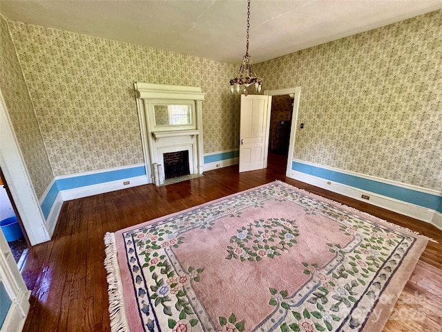 4689 Lakeview Acres Rd, Valdese, NC 28690 - living room featuring wood-type flooring, a fireplace with flush hearth, wallpapered walls, and a chandelier
