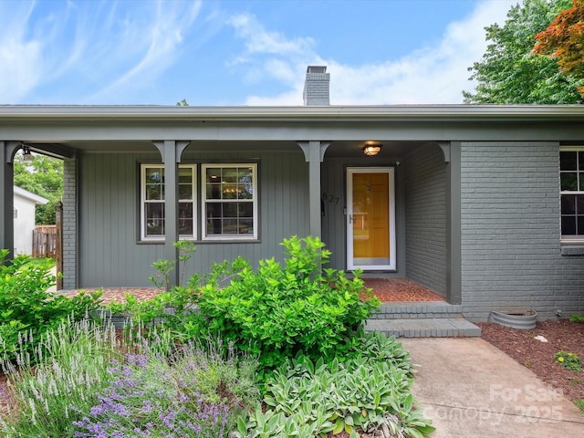 827 Fairbanks Rd, Charlotte, NC 28210 - view of front of house featuring a chimney, covered porch, and brick siding