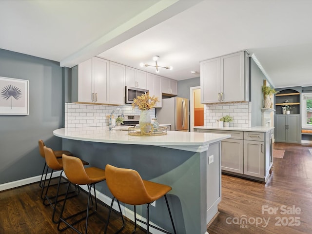 827 Fairbanks Rd, Charlotte, NC 28210 - kitchen featuring stainless steel appliances, a peninsula, a sink, and light countertops
