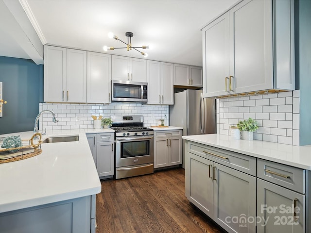 827 Fairbanks Rd, Charlotte, NC 28210 - kitchen with stainless steel appliances, a sink, a chandelier, gray cabinetry, and light countertops