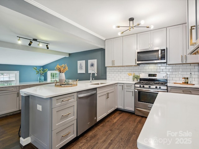 827 Fairbanks Rd, Charlotte, NC 28210 - kitchen with appliances with stainless steel finishes, a sink, light countertops, a peninsula, and tasteful backsplash
