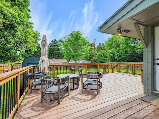 827 Fairbanks Rd, Charlotte, NC 28210 - wooden terrace with a fenced backyard, outdoor dining space, and view of scattered trees