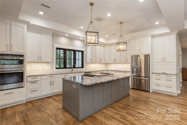 467 Dale Rd, Spruce Pine, NC 28777 - kitchen with stainless steel appliances, a chandelier, white cabinetry, light wood-style flooring, and recessed lighting