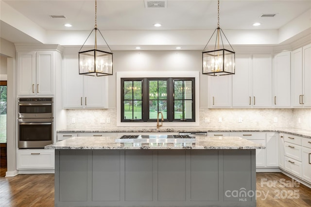 467 Dale Rd, Spruce Pine, NC 28777 - kitchen featuring a chandelier, stainless steel double oven, a kitchen island, backsplash, and recessed lighting