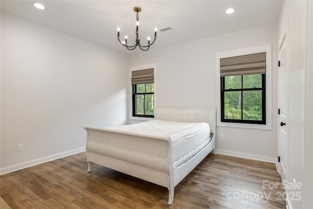 467 Dale Rd, Spruce Pine, NC 28777 - bedroom with a chandelier, wood finished floors, baseboards, and recessed lighting