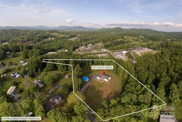 467 Dale Rd, Spruce Pine, NC 28777 - aerial view of property's location featuring a forest, a mountainous background, and property boundaries highlighted