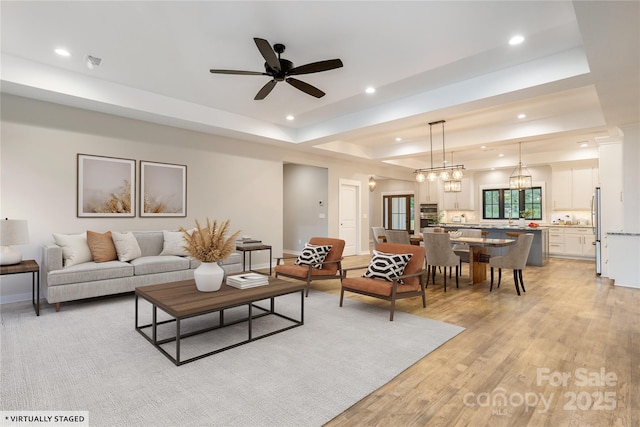 467 Dale Rd, Spruce Pine, NC 28777 - living room with a tray ceiling, recessed lighting, a ceiling fan, light wood-style flooring, and baseboards