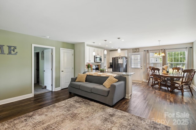 835 Jet St, Kannapolis, NC 28081 - living room with baseboards, dark wood-style flooring, a chandelier, and recessed lighting