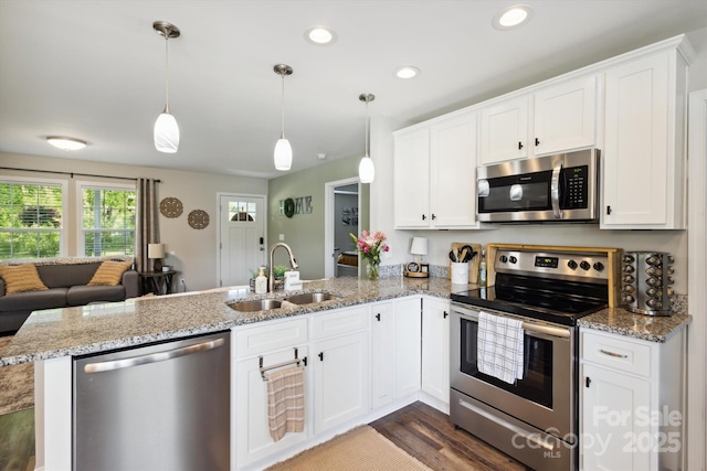 835 Jet St, Kannapolis, NC 28081 - kitchen with stainless steel appliances, a sink, a peninsula, white cabinets, and recessed lighting