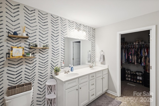 835 Jet St, Kannapolis, NC 28081 - full bath with toilet, double vanity, wallpapered walls, an accent wall, and baseboards