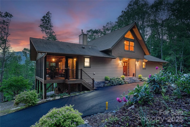 268 Trappers Run Dr, Burnsville, NC 28714 - view of front facade with a sunroom, a chimney, and a shingled roof