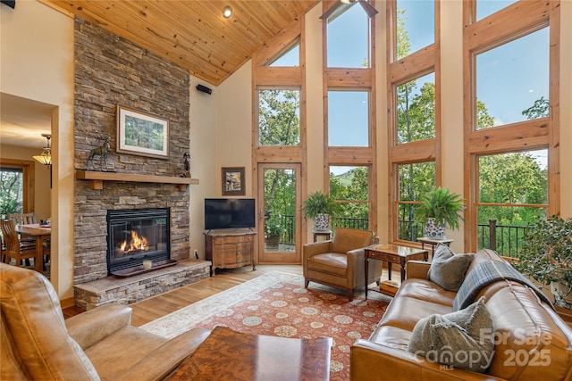 268 Trappers Run Dr, Burnsville, NC 28714 - living area featuring high vaulted ceiling, wood finished floors, a stone fireplace, and wooden ceiling