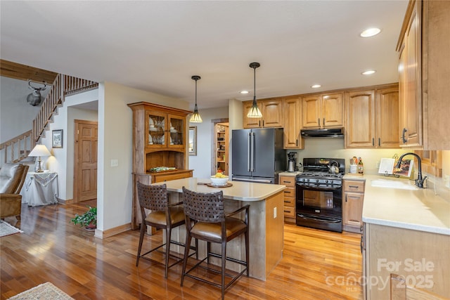 268 Trappers Run Dr, Burnsville, NC 28714 - kitchen featuring high end refrigerator, gas stove, under cabinet range hood, a sink, and a kitchen breakfast bar